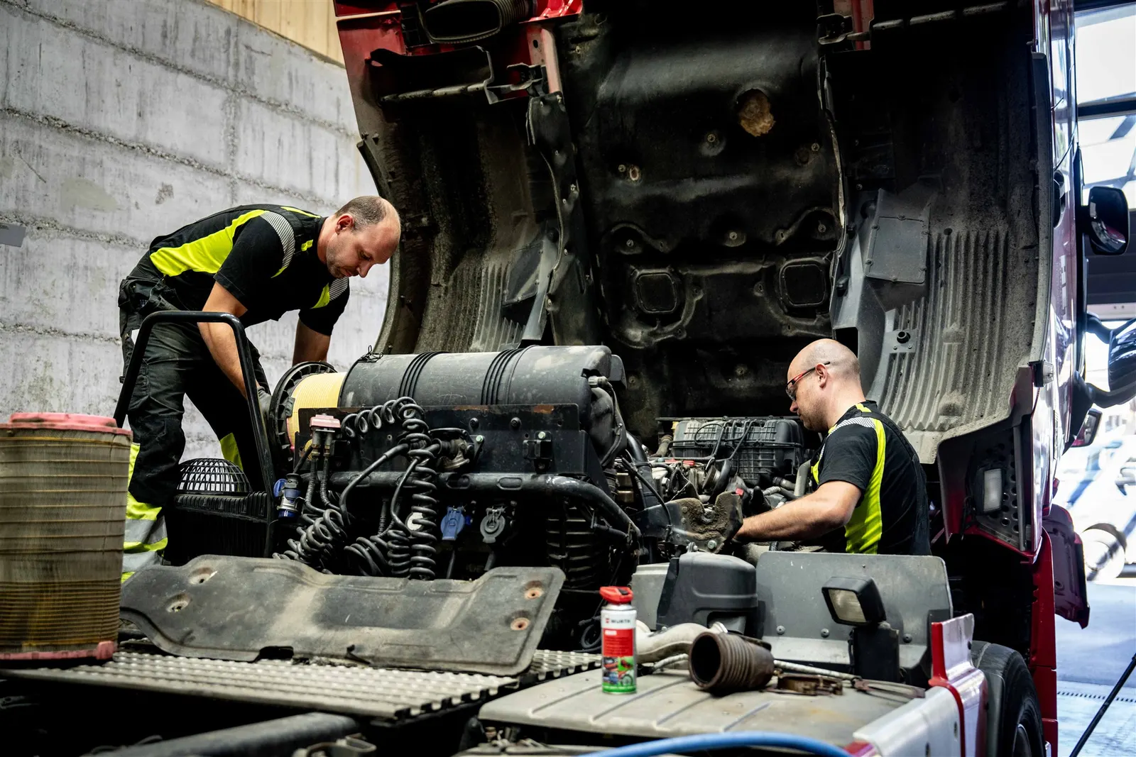 Zwei Mechaniker arbeiten am Motor eines Nutzfahrzeugs